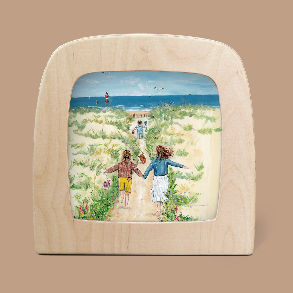 The "Silhouette Only - Sea" painting, elegantly framed with wood, depicts two children hand in hand, racing towards a lighthouse by the sea. With sandy dunes and a clear blue sky as the backdrop, it captures whimsical wonder in magical silhouettes.