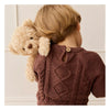 A young child with light brown hair, seen from behind in a brown knitted sweater, holds the Snuggle Bunnies - Arthur the Bear, made from super soft toys fabric, over their shoulder. Ships in approximately one week.