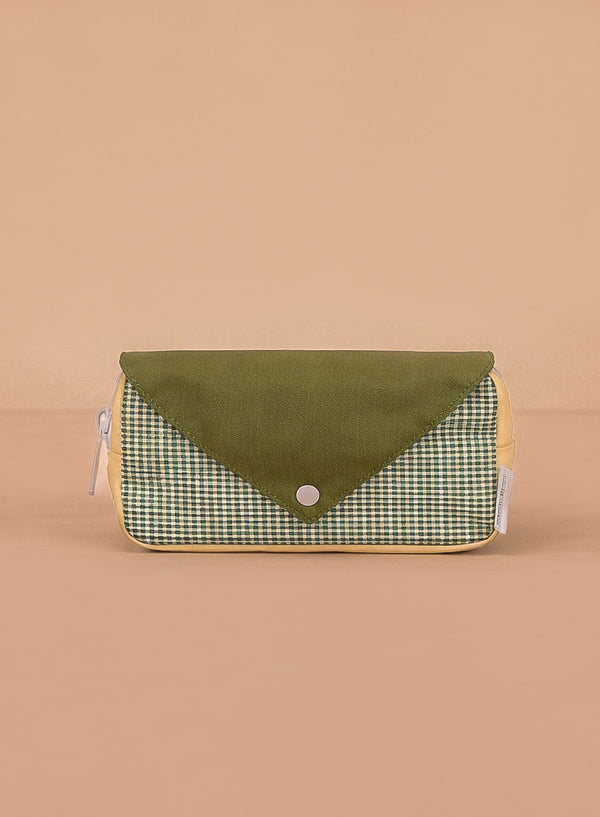 The Sticky Lemon Fanny Pack Small - Envelope - Tickling Grass is a rectangular pouch made from recycled PET bottles with a green snap flap, green and white checkered front, yellow sides, and shown on a plain beige background.