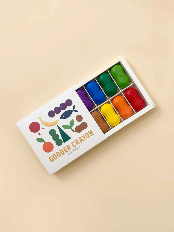 A box of non-toxic Peanut Crayon watercolors containing eight vibrant and glossy rectangular blocks of paint, arranged in a simple white tray with a transparent lid, displayed on a pale background.