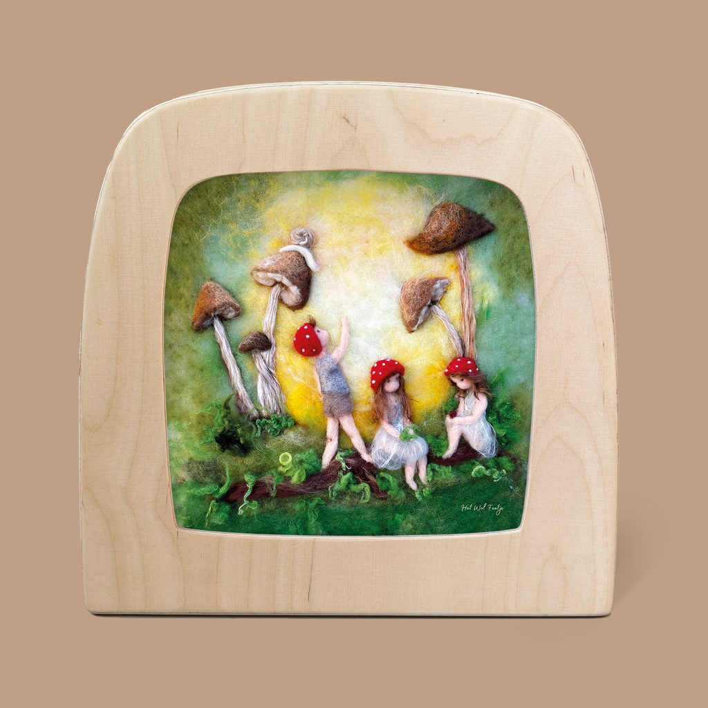 The product "Silhouette Only - Children Of The Forest for Toverlux Lamp" showcases a whimsical scene of three gnome-like figures with red hats, depicted as silhouettes beneath large mushrooms. These figures engage with nature in an enchanting setting, where the background is illuminated with warm, glowing tones.