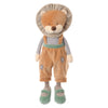 The Bukowski - Happy Mael Lion stands upright against a white background, dressed in brown overalls, a striped shirt, and green shoes. Its soft mane and stitched facial features make it the perfect cuddle buddy.