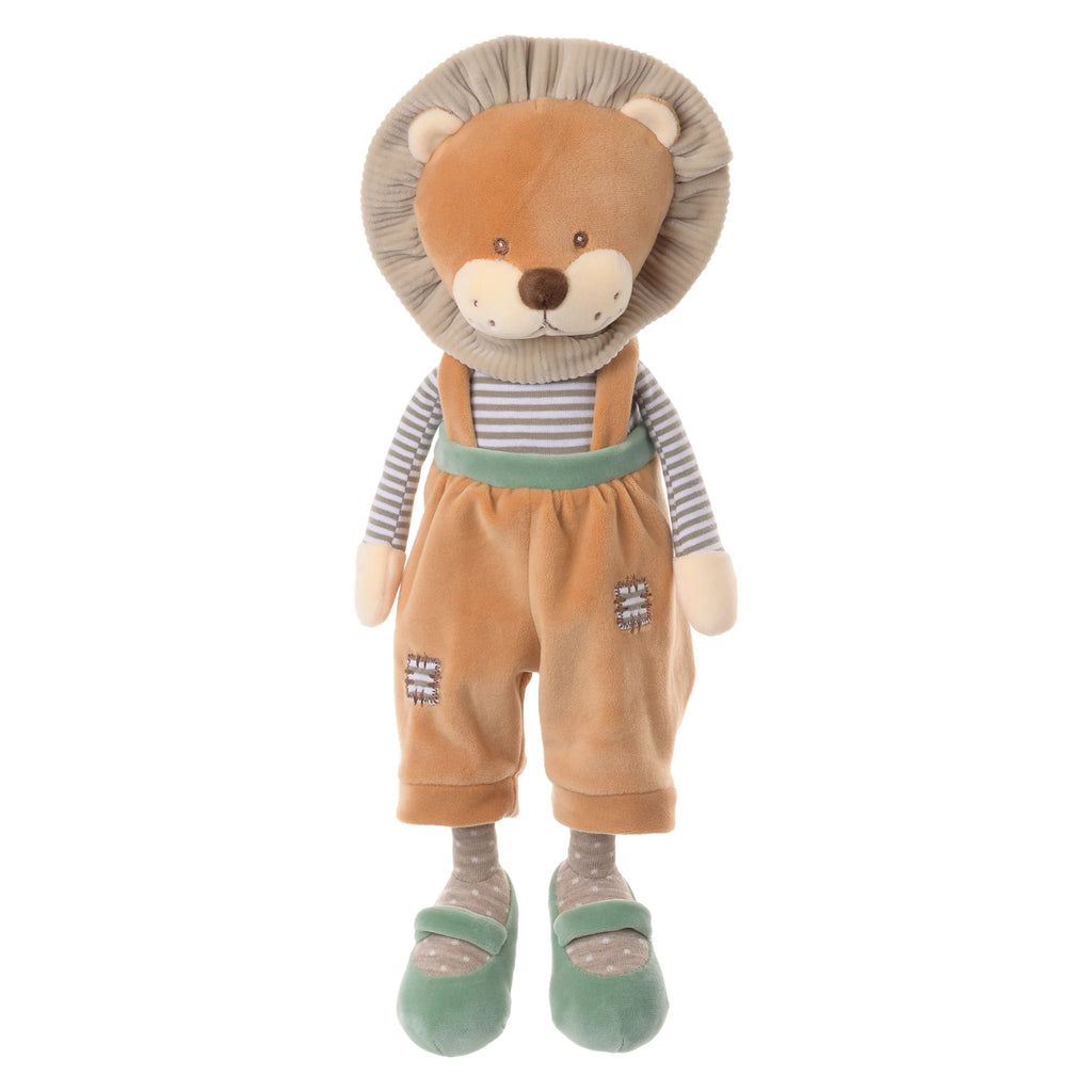 The Bukowski - Happy Mael Lion stands upright against a white background, dressed in brown overalls, a striped shirt, and green shoes. Its soft mane and stitched facial features make it the perfect cuddle buddy.
