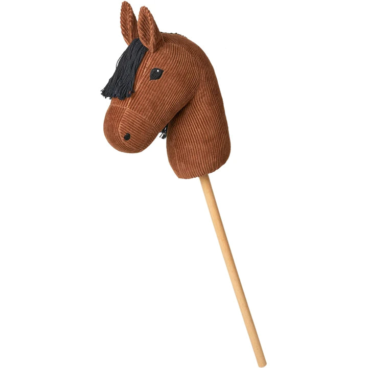 A Hobby Horse, reminiscent of a classic toy horse head on a stick. The horse head, crafted by Fabelab, is made of brown corduroy fabric with black yarn for the mane and two black eyes. The stick, fashioned from light-colored wood, acts as the horse's body.