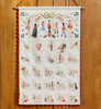 Nutcracker Embroidered Hanging Advent Calendar - Red featuring embroidered nutcracker figurines and pockets numbered one through twenty-five.