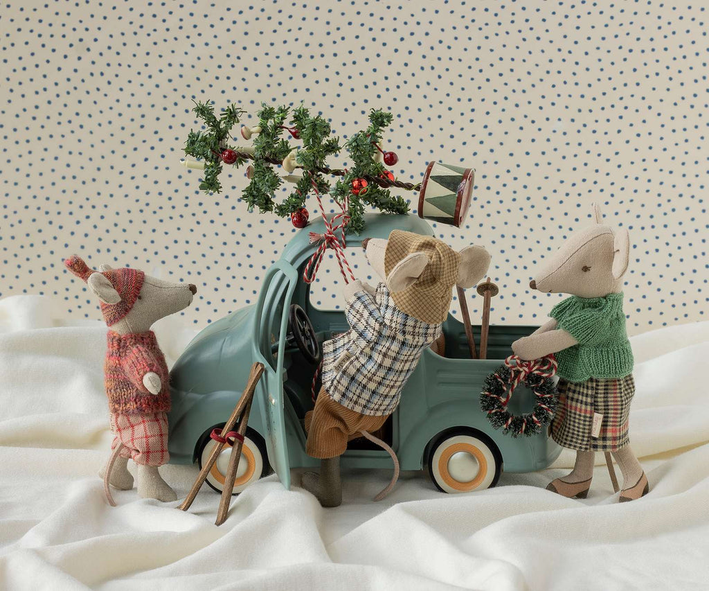 Three toy mice in winter outfits bring festive cheer to the PRE-ORDER: Maileg Truck, Mouse (Estimated Arrival Early November). One mouse drives the charming toy truck while another carries a wreath and the third looks on. With a tiny tree strapped to the roof and delightful holiday accessories, this set creates fun, imaginative seasonal play scenes.