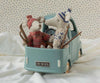 Two Maileg mice in knit sweaters and hats sit in the PRE-ORDER: Maileg Truck, Mouse (Estimated Arrival Early November), a toy car with skis attached to the sides, on a white blanket with a dotted background—setting the scene for whimsical mouse family adventures.