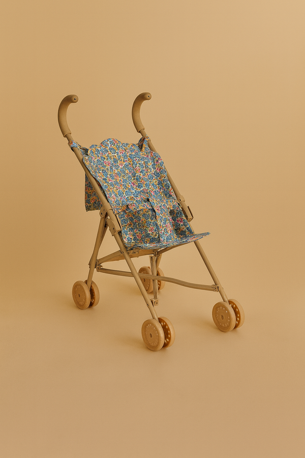 The Konges Sloejd Doll Stroller - Rose Flower is a lightweight, tan stroller with wooden double wheels and a removable floral fabric seat, shown against a plain beige background.