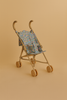 The Konges Sloejd Doll Stroller - Rose Flower is a lightweight, tan stroller with wooden double wheels and a removable floral fabric seat, shown against a plain beige background.