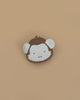 The Donsje Leather Kapi Backpack - Monkey features a small, round design resembling a cartoon monkey face with brown and white leather, two white ears, and is displayed on a plain beige background.