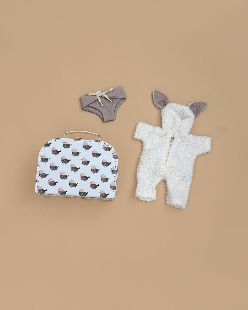 The Minikane 11" Doll Clothing Jeannot Jumpsuit & Diaper in Suitcase Set features cozy terrycloth cotton pieces and a cute small suitcase, perfect for styling your doll with comfort and charm.