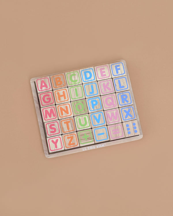 ABC Learning Blocks is a wooden alphabet puzzle with colorful square letter pieces in pastel shades, arranged in rows on a light brown board. It's the perfect educational toy for toddlers to develop early literacy skills from A to Z.