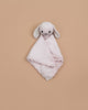 The Cuddle + Kind Organic Cotton Baby Bunny Lovey (Blush) is a soft, light pink heirloom-quality comforter with a cute bunny head and floppy ears, shown on a plain beige background.
