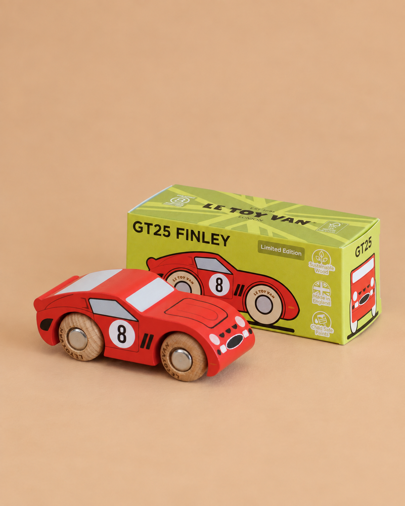 A vintage-inspired red toy race car with the number 8 and wooden wheels, named No. 4 GT25 Finley and made in England, sits beside its green box labeled “GT25 Finley” and “Limited Edition” on a beige background.