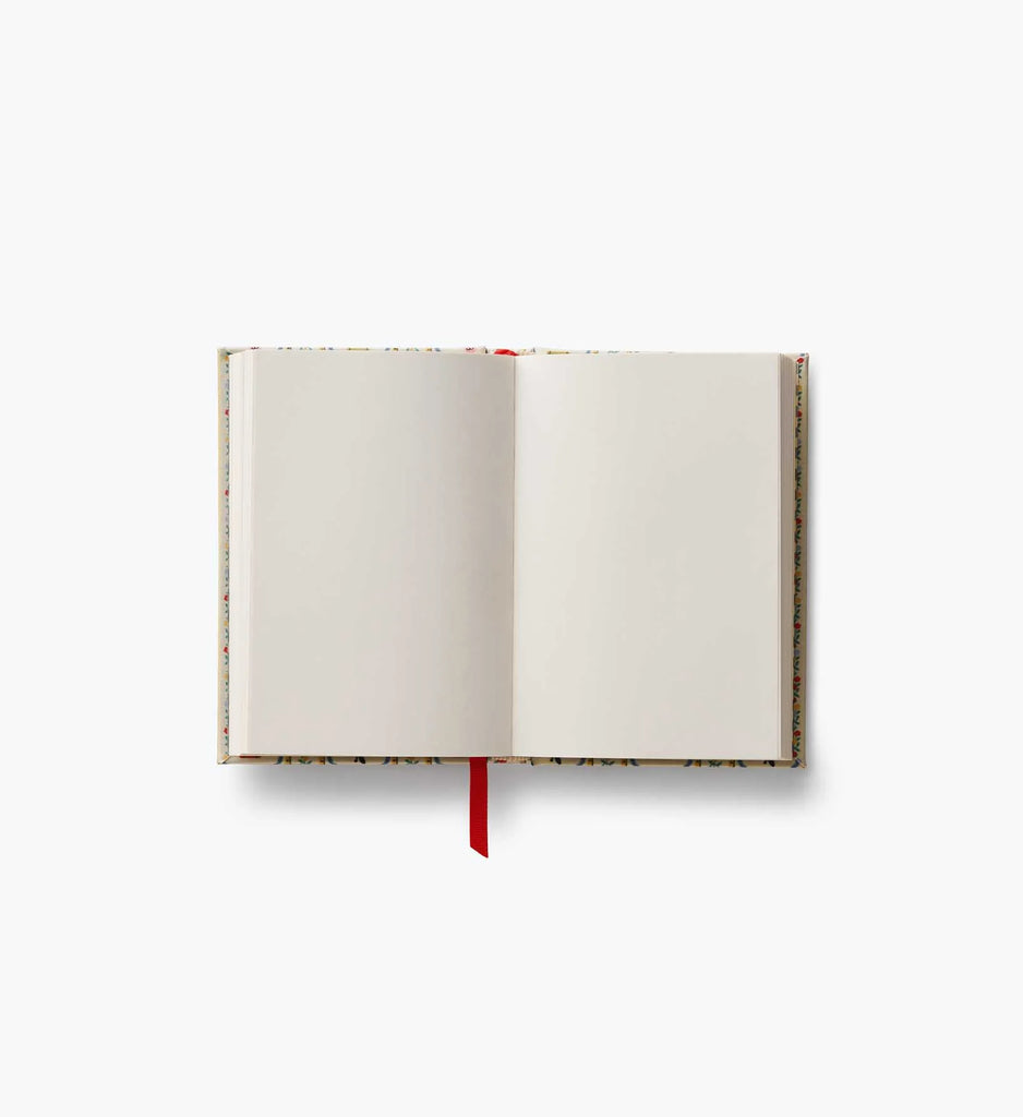 A Schoolhouse Mini Embroidered Journal with unlined pages and a red ribbon bookmark lies open and flat on a white background.