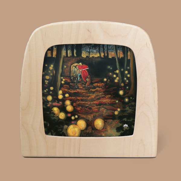 The framed artwork, "Silhouette Only - Saint Martin for Toverlux Lamp," features a forest scene with a person in a red cloak walking beside a donkey. The use of translucent material and glowing orbs scattered among the trees illuminates the forest floor, crafting an enchanting atmosphere.