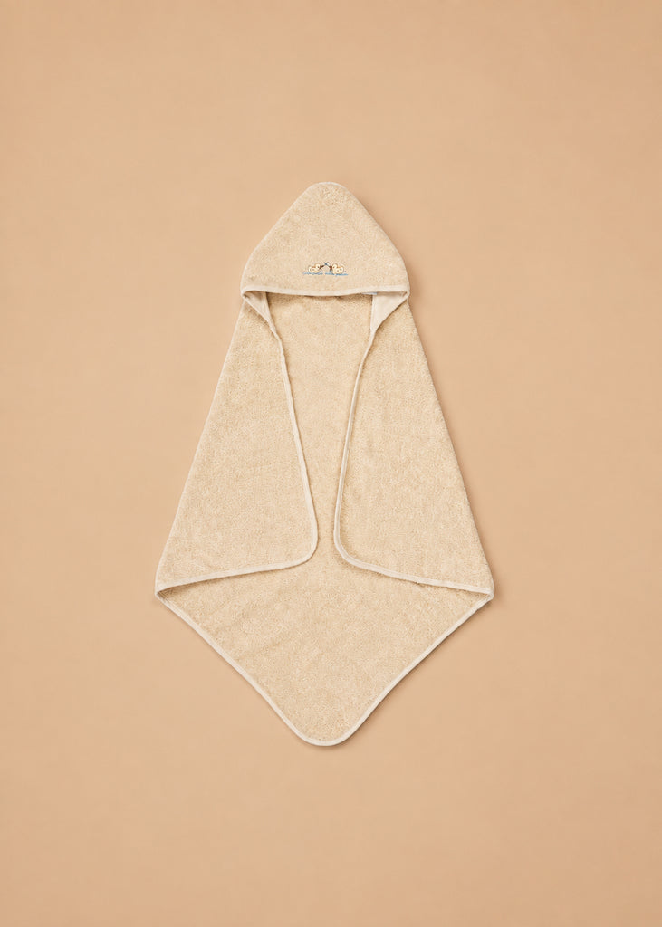The Konges Sloejd Organic Cotton Baby Towel, in a beige shade with a hood and rounded corners, is displayed flat on a tan background. The soft towel features a small embroidered design on the hood.