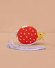 The Sticky Lemon Wallet Bag - Ladybug is a small red and yellow ladybug-shaped kids' PU leather bag with white polka dots and a lavender strap, shown on a plain beige background.