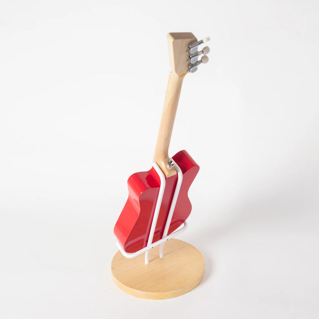 A red electric Loog Mini guitar model supported by a Guitar Stand For Loog Mini, positioned vertically against a white background. The focus is on the craftsmanship and design of the guitar.