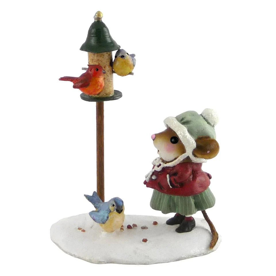 The Wee Forest Folk Tiny Collectible - Feathered Friends features a hand-sculpted mouse in a green coat and bonnet standing on snow by a bird feeder with three colorful birds, plus one more bird beside this charming miniature scene.