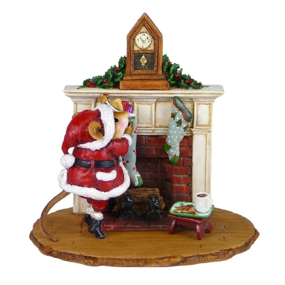 The Wee Forest Folk Tiny Collectible - A Visit From St. Nick features a hand-sculpted mouse dressed as Santa, reaching into a green stocking by a decorated fireplace with classic holiday details.