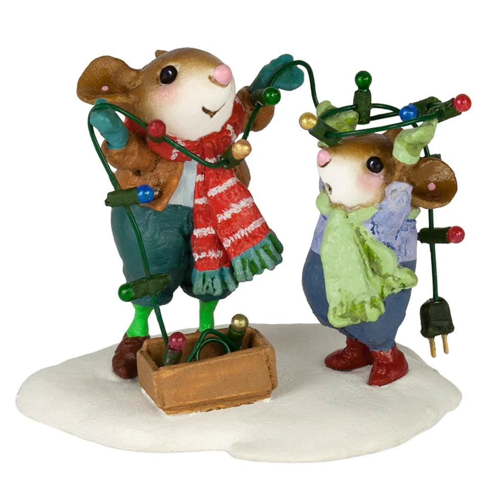 The Wee Forest Folk Tiny Collectible - Merry & Bright (Not a Toy) features two festive mice in winter clothes on snow. One wraps Christmas lights around the other, who has lights on its head, with a small box nearby—a joyful hand sculpted scene.