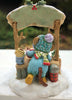 Wee Forest Folk Tiny Collectible - Hot Cocoa Comin' Up! features a hand-sculpted mouse in a blue coat, striped scarf, and yellow boots at a snowy stall with a mug, thermos, plaid container, and green awning with red berries.