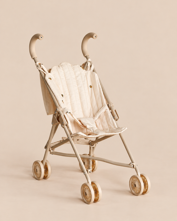 Konges Sloejd Doll Stroller - Lemon in cream with a quilted seat featuring small lemon patterns and double wheels.