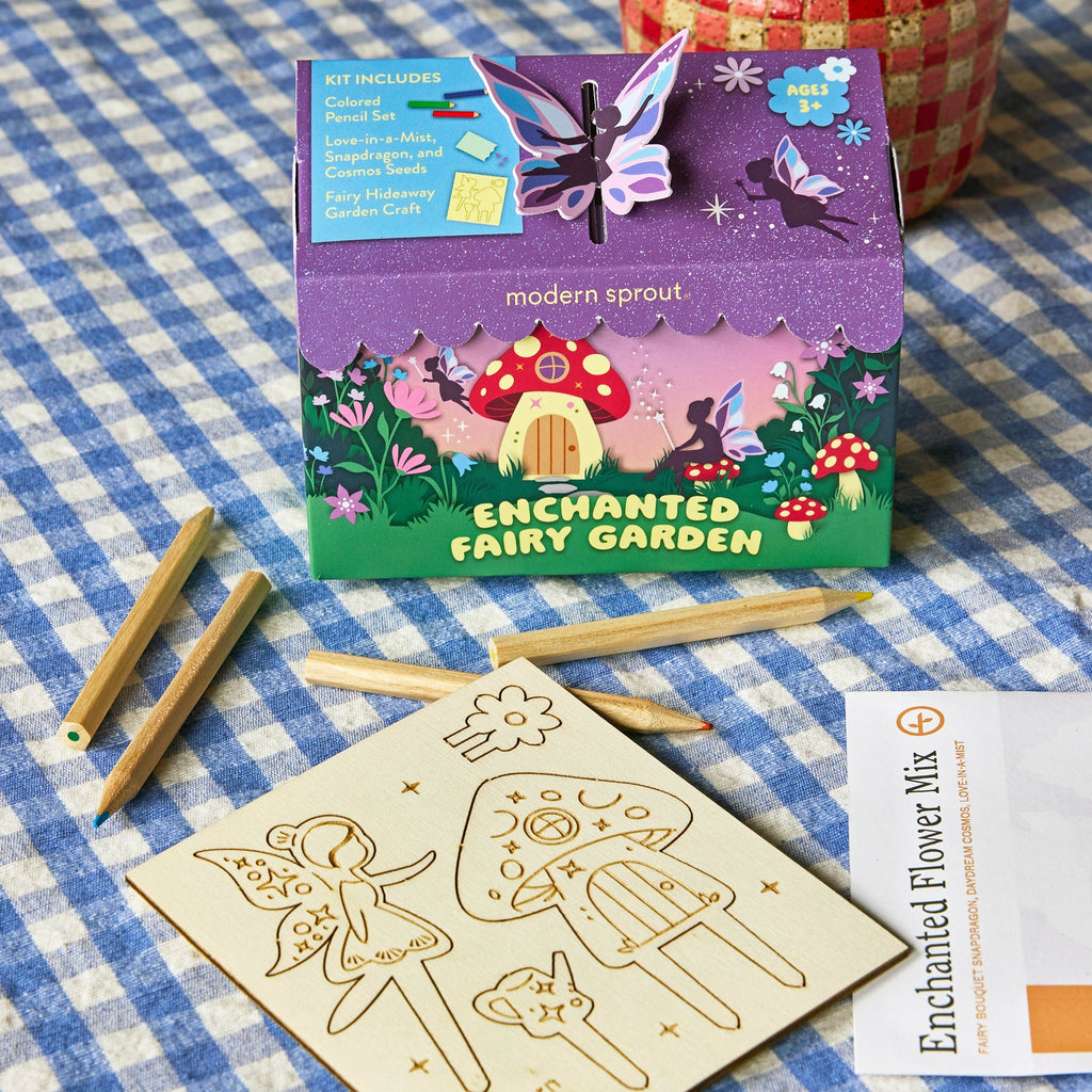 The Magical Minds Garden Kit - Enchanted Fairy Garden for kids includes a butterfly decoration, colored pencils, a wooden sheet with fairy and mushroom outlines, and an Enchanted Flower Mix to create a magical pollinator habitat.