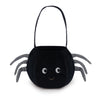 The Mon Ami - Spider Halloween Bag is a black trick-or-treat bag shaped like a spider, featuring striped legs, a sturdy handle, and a smiling face with two large eyes—perfect for carrying treats on Halloween night.
