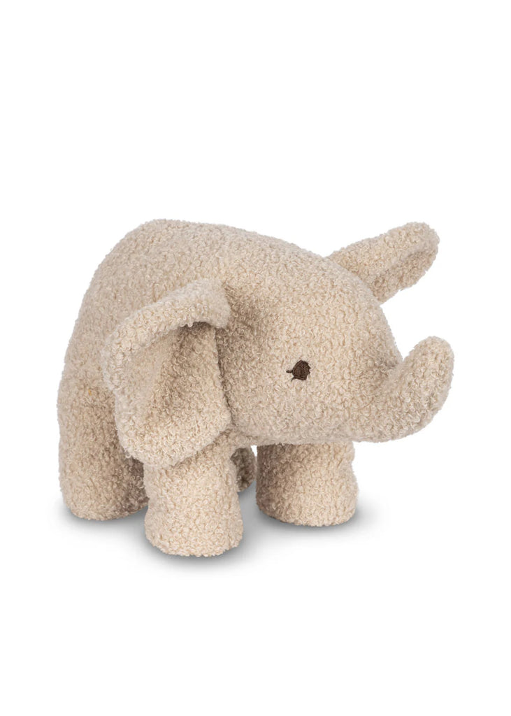 The Elephant Teddy Stuffed Animal is a small, plush toy crafted from soft, beige textured fabric and filled with polyester. This snuggly elephant features large floppy ears, a short trunk, and simple stitched eyes. Standing on four legs, it boasts a slightly fuzzy, wool-like appearance.