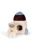 The Teddy In Outer Space Stuffed Animal - Rocket is a plush toy set featuring a beige teddy bear dressed in an embroidered astronaut suit and a soft rocket ship. The rocket ship, crafted from recycled polyester, has blue and burgundy accents and includes a round opening in the middle, providing a cozy home for the teddy bear astronaut.