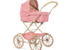 The Konges Sloejd Doll Pram - Bubblegum Check features a vintage beige frame, large spoked wheels, and pink and white checkered quilted fabric with a cozy padded mattress, displayed on a crisp white background.