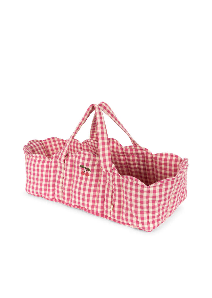 The Konges Sloejd Doll Lift - Bubblegum Check is a pink and white gingham cotton carrier with two fabric handles and scalloped edges, OEKO-TEX certified—perfect for children to carry dolls or soft toys.