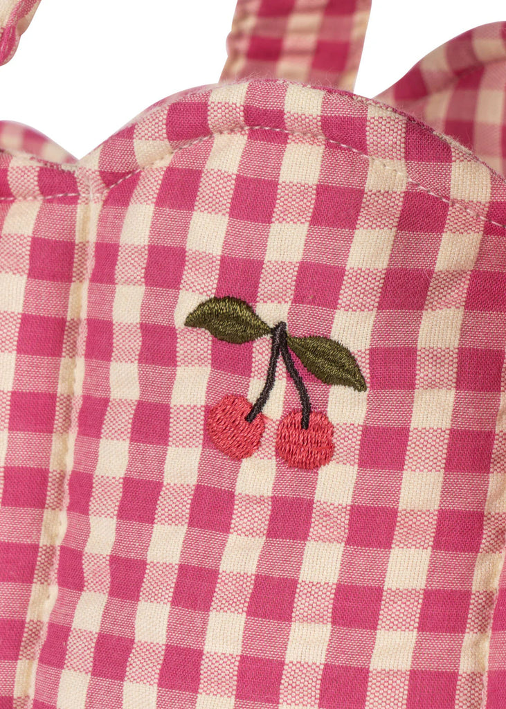 Close-up of the Konges Sloejd Doll Lift - Bubblegum Check, featuring pink and white checkered cotton fabric with two red cherries and green leaves embroidered on it.