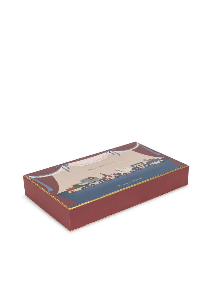 Konges Sloejd Wooden Animal Train comes in a rectangular red box with gold trim, adorned with an illustrated scene of toy cars, trucks, and a delightful wooden train with magnetic train cars on the lid. The design features a blue and beige background accented by a decorative border and bows.