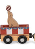 The Konges Sloejd Wooden Animal Train features a charming circus car crafted from beechwood, with a cutout of a seal balancing a red-striped ball. This delightful car displays red, white, and blue decorative panels, four black wheels, and is compatible with magnetic train cars for endless play possibilities.