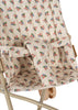Close-up of the Konges Sloejd Doll Stroller - Verona Blues, showing beige floral and dot fabric in red, green, and blue, safety straps, double wheels, and a light tan metal frame.