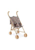 The Konges Sloejd Doll Stroller - Kyoto is a lightweight, beige stroller with curved handles, double wheels, and a green floral-patterned fabric seat, shown against a plain white background.