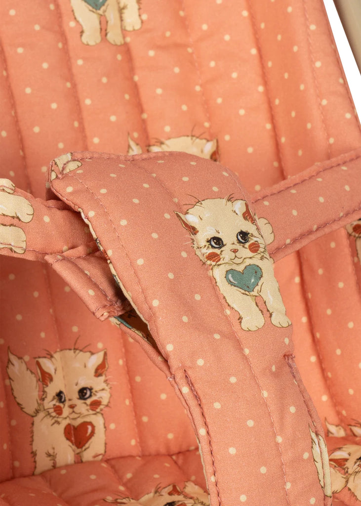 Close-up of the Konges Sloejd Doll Stroller - Ciao Miao Rose, showcasing pink quilted fabric adorned with small white polka dots and charming illustrated kittens holding hearts.
