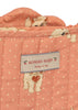The Konges Sloejd Doll Stroller - Ciao Miao Rose showcases a quilted peach-colored fabric with white polka dots and adorable printed kittens. Ideal for decorating a doll stroller, this delightful textile features a label reading “Konges Sløjd” accompanied by small cherry icons and the phrase “cherry on top.”.