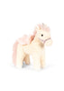 Konges Sloejd Starlight Unicorn Stuffed Animal: A plush, cream-colored unicorn soft toy featuring a pink mane and tail, small silver horn, floral bridle, and shimmering pink wings.