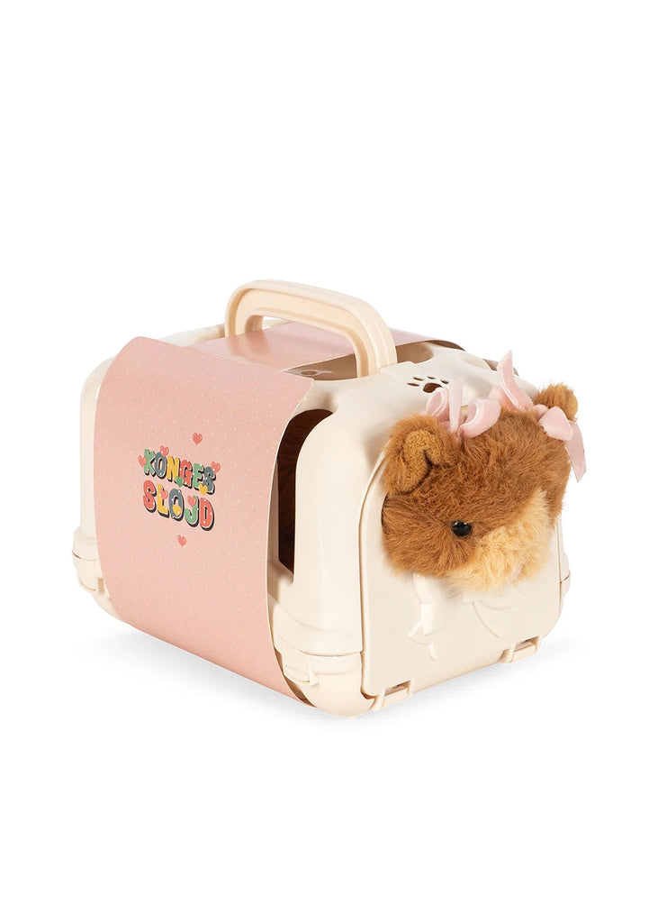 A mini toy animal, the Konges Sloejd Take Care of Me Animals - Cat features a plush feline with a pink bow peeking out of a cream pet carrier adorned with a pink label that reads “You’re So Cute.” Perfect for fans of ‘Take Care of Me’ animals, it’s an adorable companion ready for imaginative adventures.