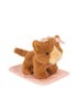 A small brown Konges Sloejd Take Care of Me Animals Cat with a pink bow sits on a pink polka dot blanket.