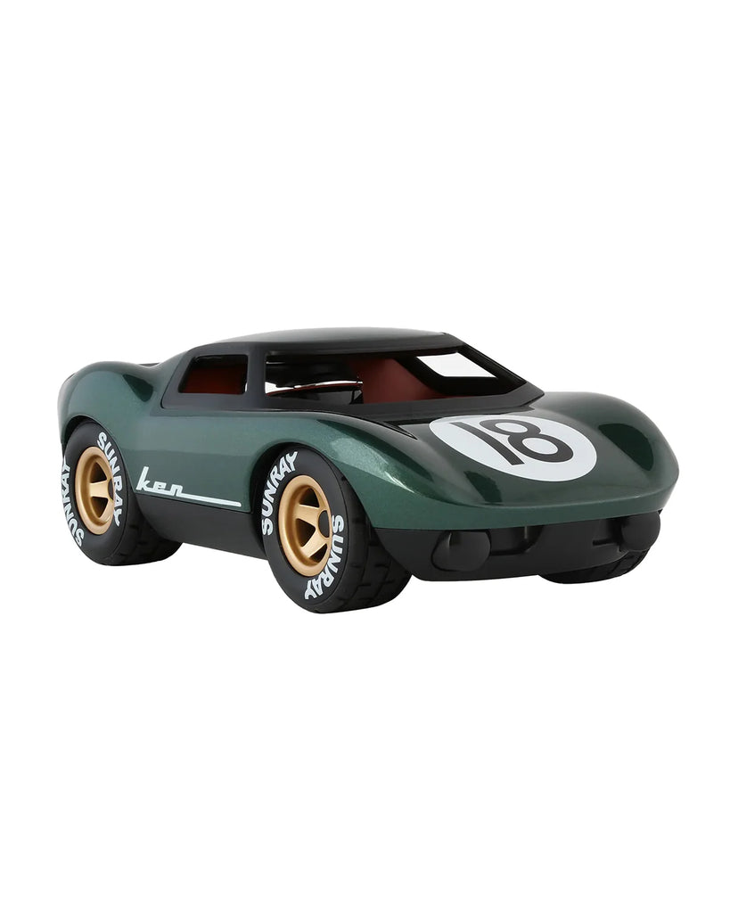 The Car Mini KEN ROGERS Metallic Green 7in is a collectible toy car with gold wheels, white racing decals, and the number 18 on the hood. Viewed from the front, its tires read "SUNDAY" and "SUNRAY"—ideal for Playforever fans.
