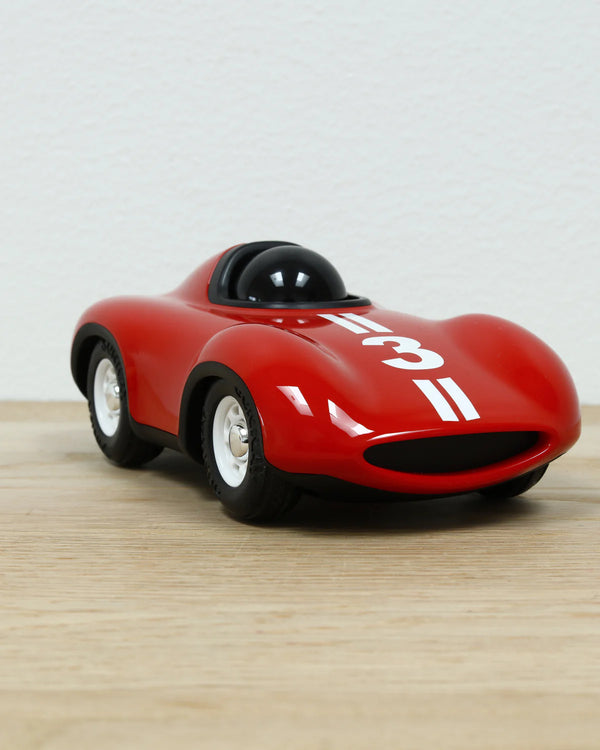 The Playforever Car MINI SPEEDY LE MANS Red, featuring a number 3, white hood stripes, sleek design, and black-tinted windshield, is displayed on a light wooden surface with a plain white background.