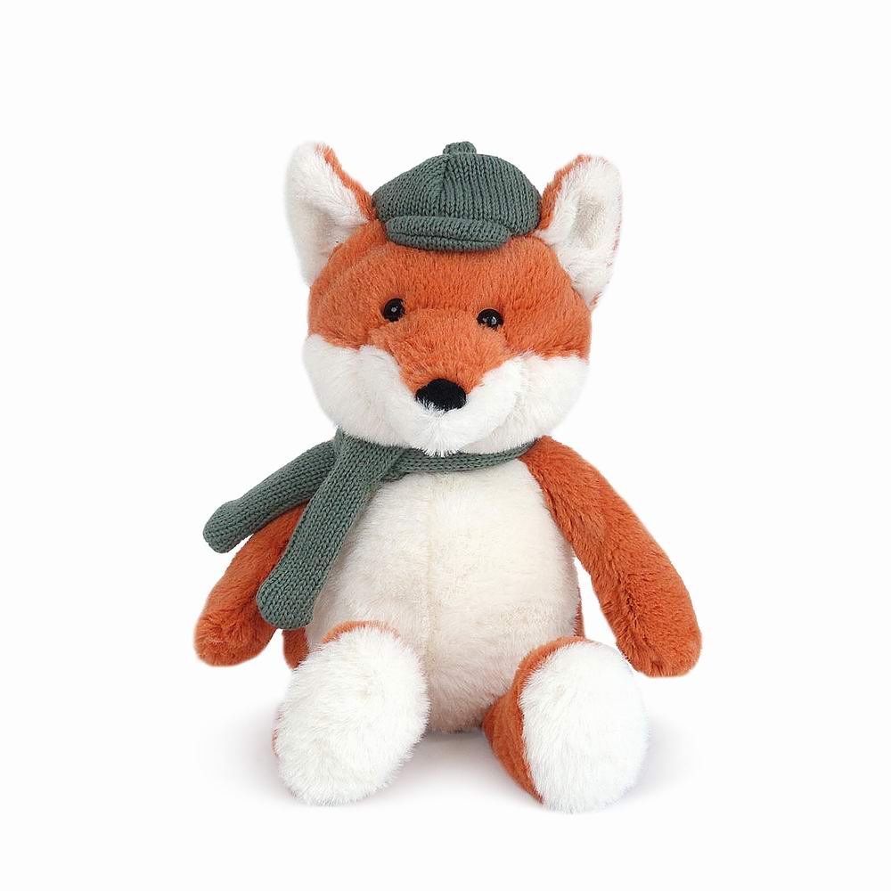 The Frederick Fox Plush Toy features orange and white fur, and sits upright wearing a green knit hat and matching scarf against a white background.