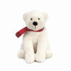The Mon Ami North Polar Bear Plush Toy sits upright, featuring a cozy red and black plaid scarf around its neck, all set against a plain white background.