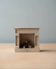 The Maileg Living Room Set - Mint features a charming, small wooden fireplace with three miniature logs—perfect for adding warmth and style to your Maileg dollhouse accessories collection.