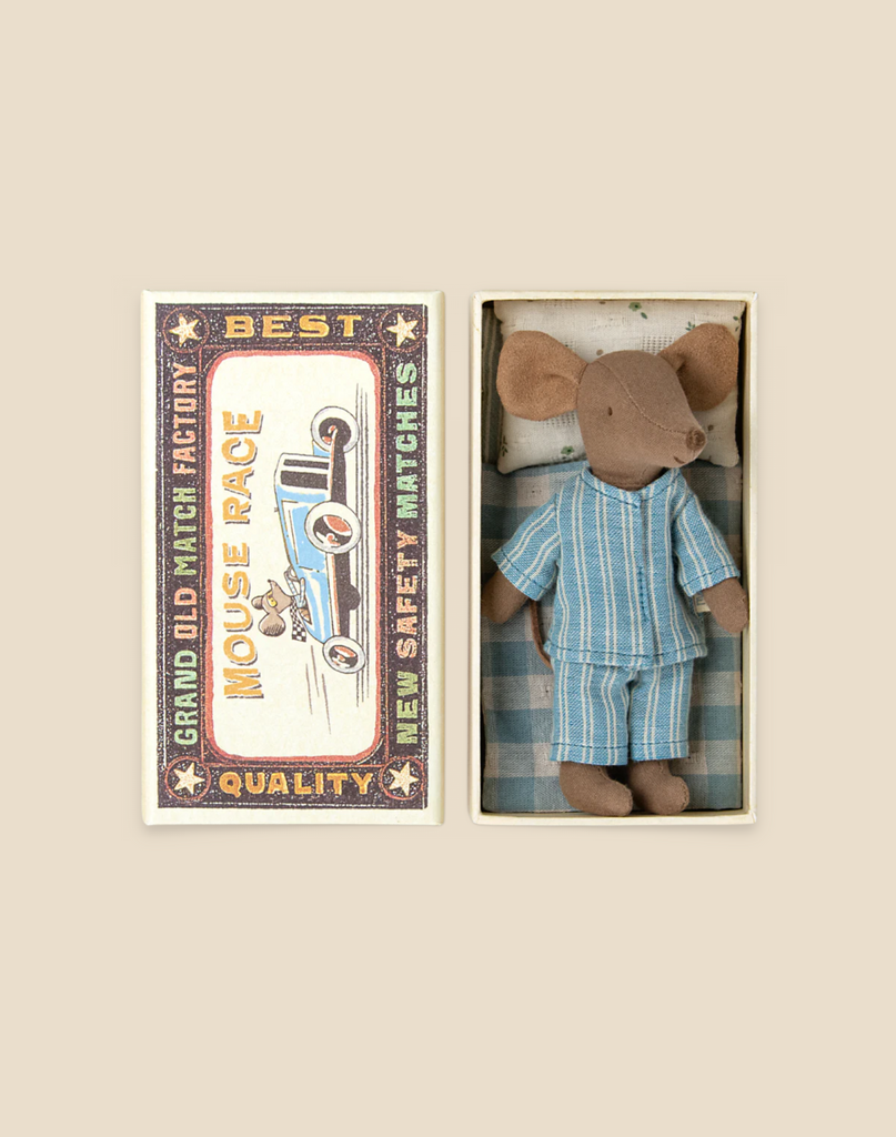 A vintage-style packaging box with an illustration of a Maileg Big Brother Mouse in Box race car printed next to text, beside which lies a small plush Maileg Big Brother Mouse in Box toy dressed in a striped blue and white outfit inside an open box.